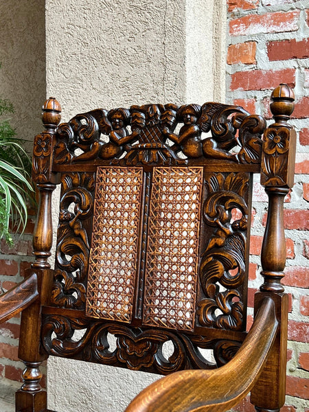 Antique English Arm Chair Carved Oak Cane Seat Renaissance Cherubs Fireside